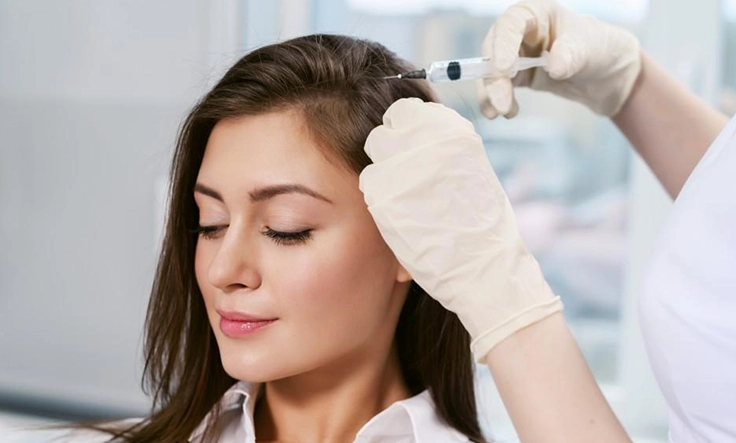 A woman receiving a hair regrowth injection treatment to combat hair loss after weight loss.